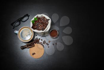 Fresh delicious coffee. Still life with coffee on black wooden background. Copy space for your text. Top view. Flat lay.