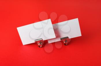 Photo of blank business cards on red paper background. Template for ID.