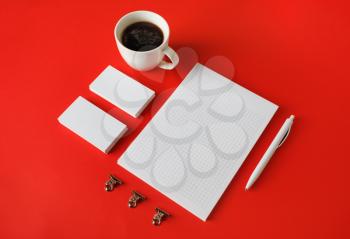 Blank stationery set on red paper background. Corporate identity template. Responsive design mockup.