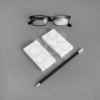 Blank branding identity set on gray paper background. Business cards, pencil and glasses. Corporate stationery template. For design presentations and portfolios.