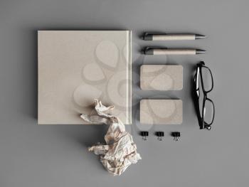 Photo of blank kraft stationery on gray paper background. Top view. Flat lay.