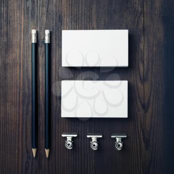 Blank business cards and pencils on wooden background. Stationery mock up. Flat lay.