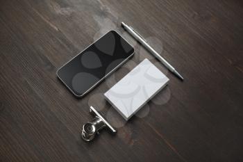 Smartphone, blank business card and pen on wooden background. Blank stationery set. Mockup for branding identity.