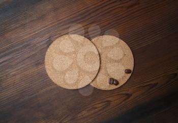 Blank beer coasters and coffee beans on wood table background. Top view. Flat lay.