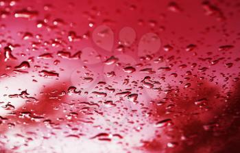 Red water drops after rain bokeh background