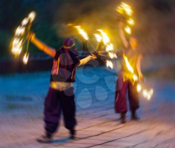 Horizontal vivid two female fakir playing with fire motion abstraction background backdrop