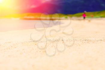 Blurred person on the sandy beach with light leak bokeh background hd
