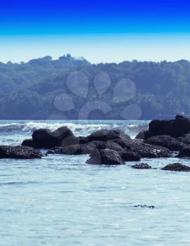 Vertical dramatic soft pale rocks in ocean horizon landscape background backdrop