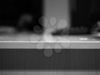 Horizontal black and white table with keyboard bokeh background