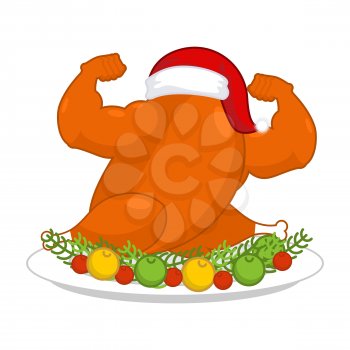 Christmas turkey strong in Santa red cap. Fitness food for New Year. powerful chicken on plate. Roast fowl on dish with vegetables

