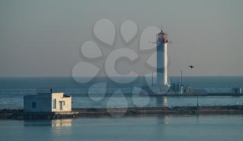 Odessa lighthouse in bright sunny winter day in the middle of the Black Sea. Blue sky and calm water