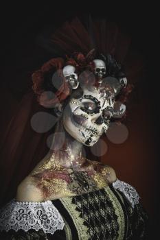 Santa Muerte Young Girl with Artistic Halloween Makeup and with Sculls in her Hair