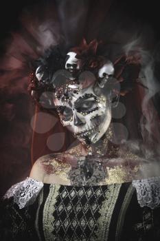 Santa Muerte Young Girl with Artistic Halloween Makeup and with Sculls in her Hair