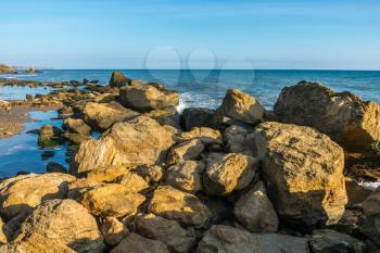 Big stones on the edge of the Black Sea. Autumn day by the sea near the village of Fontanka, Odessa region, Ukraine
