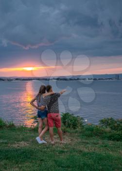 Nessebar, Bulgaria – 07.09.2019. Romantic couple admires the sunset in Nessebar, Bulgaria