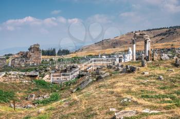 The ruins of the ancient city of Hierapolis in Pamukkale, Turkey, on a sunny summer day