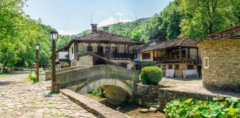 Stone bridge in the Etar Architectural Ethnographic Complex in Bulgaria on a sunny summer day. Big size panoramic photo
