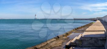 Lighthouse at the entrance to the harbor of Odessa seaport, on a sunny summer day