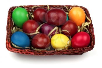 Basket with colorful easter eggs isolated on a white background