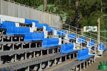 The seats in the stadium. Blue seats in the stands.