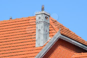 The house with a roof of tiles. The house with gables, windows and tiled roof, equipped with overflow.