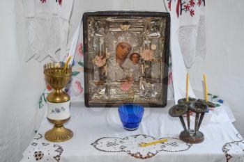 Prayer Area of the house. Mother of God and candles in candlesticks on the table.