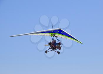 Russia, Veselovka - September 6, 2016: Trike, flying in the sky with two people. Extreme Entertainment travelers