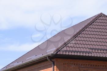 The roof of corrugated sheet. Roofing of metal profile wavy shape.