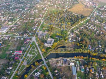 Top view of the village. One can see the roofs of the houses and gardens. Road and water in the village. Village bird's-eye view.