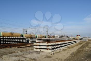 New rails and sleepers. The rails and sleepers are stacked on each other. Renovation of the railway. Rail road for the train.