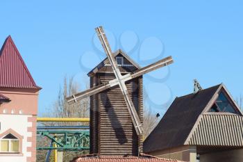 Decorative wooden mill. Mill to decorate the streets. Houses and buildings.