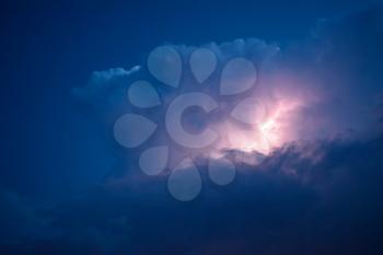 Lightnings in storm clouds. Peals of a thunder and the sparkling lightnings in clouds.