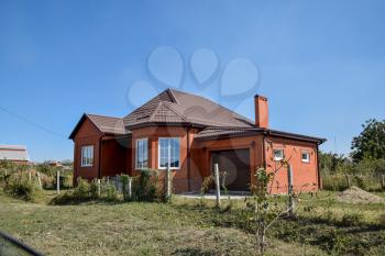 Detached house with a roof made of steel sheets. Roof metal sheets. Modern types of roofing materials.