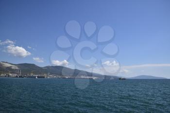 Sea bay landscape Tsemess. Mountains and clouds in the sky. In the distance can be seen the Marine cargo port.