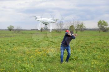 A man hides himself from a collision with a drone. Quadrocopter flies to the person.