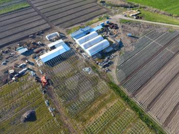 Frameworks of greenhouses, top view. Construction of greenhouses in the field. Agriculture, agrotechnics of closed ground.