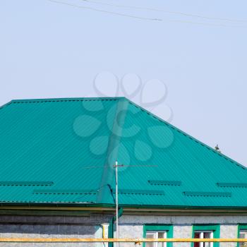 Green metal profile corrugated roofing on the house