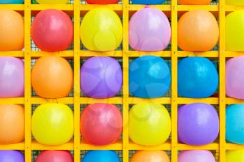 Inflatable balls in square shelves. Multicolored balls background of balls.