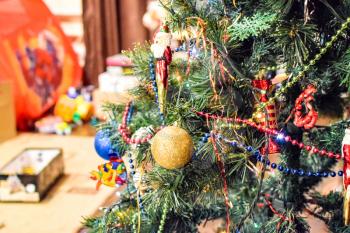 Childrens toys on the floor against the background of the Christmas tree