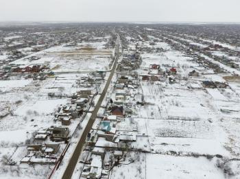 Winter view from the bird's eye view of the village. The streets are covered with snow.