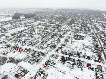 Winter view from the bird's eye view of the village. The streets are covered with snow.