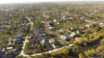 Top view of the village. The village of Poltavskaya. Top view of the village. One can see the roofs of the houses and gardens. Village bird's-eye view.