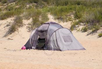Tourist tent on the sand. Parking of tourists on the sandy beach.