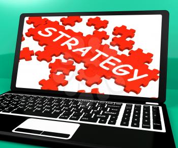 Strategy Puzzle On Notebook Showing Online Solutions And Business Strategies