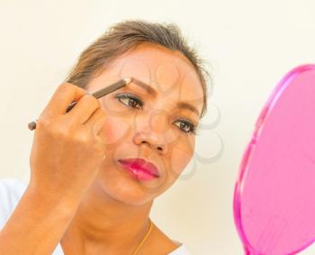 Applying Eyebrow Makeup Showing Woman And Cosmetics