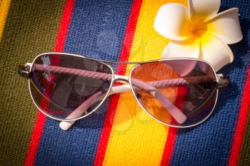 Sunglasses On Towel Showing Sunny Exotic Vacation