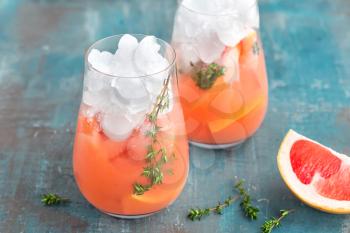 Grapefruit and thyme gin cocktail, refreshing drink with ice