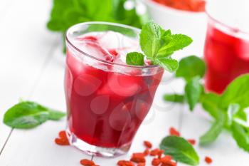 Healthy detox drink with goji berries infused in water with ice, cold refreshing beverage