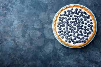 Delicious dessert blueberry tart with fresh berries and whipped cream, sweet tasty cheesecake, berry pie. French cuisine