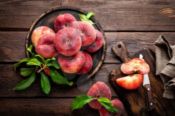 Peach, saturn or donut peaches with leaves